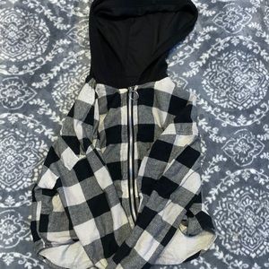 A zip up jacket that is black, gray, and white